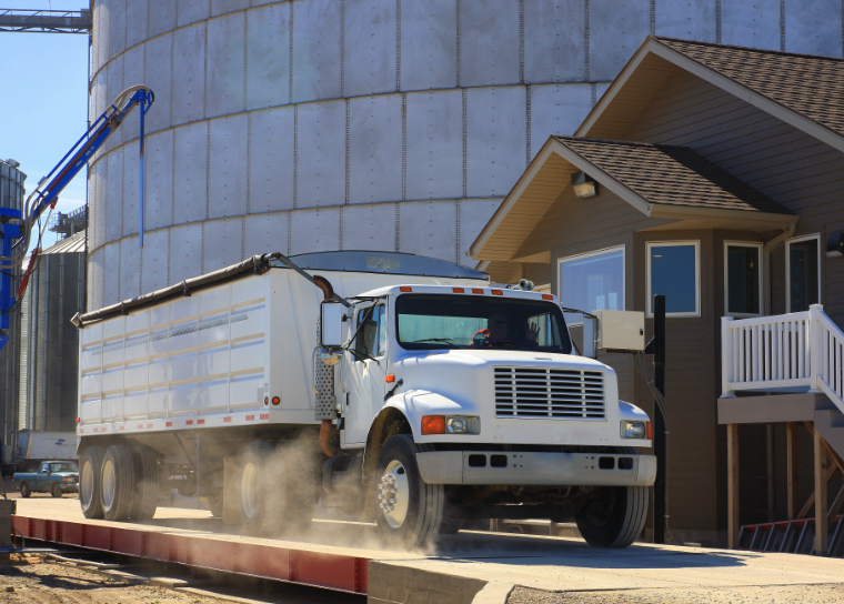 white truck in front of silo